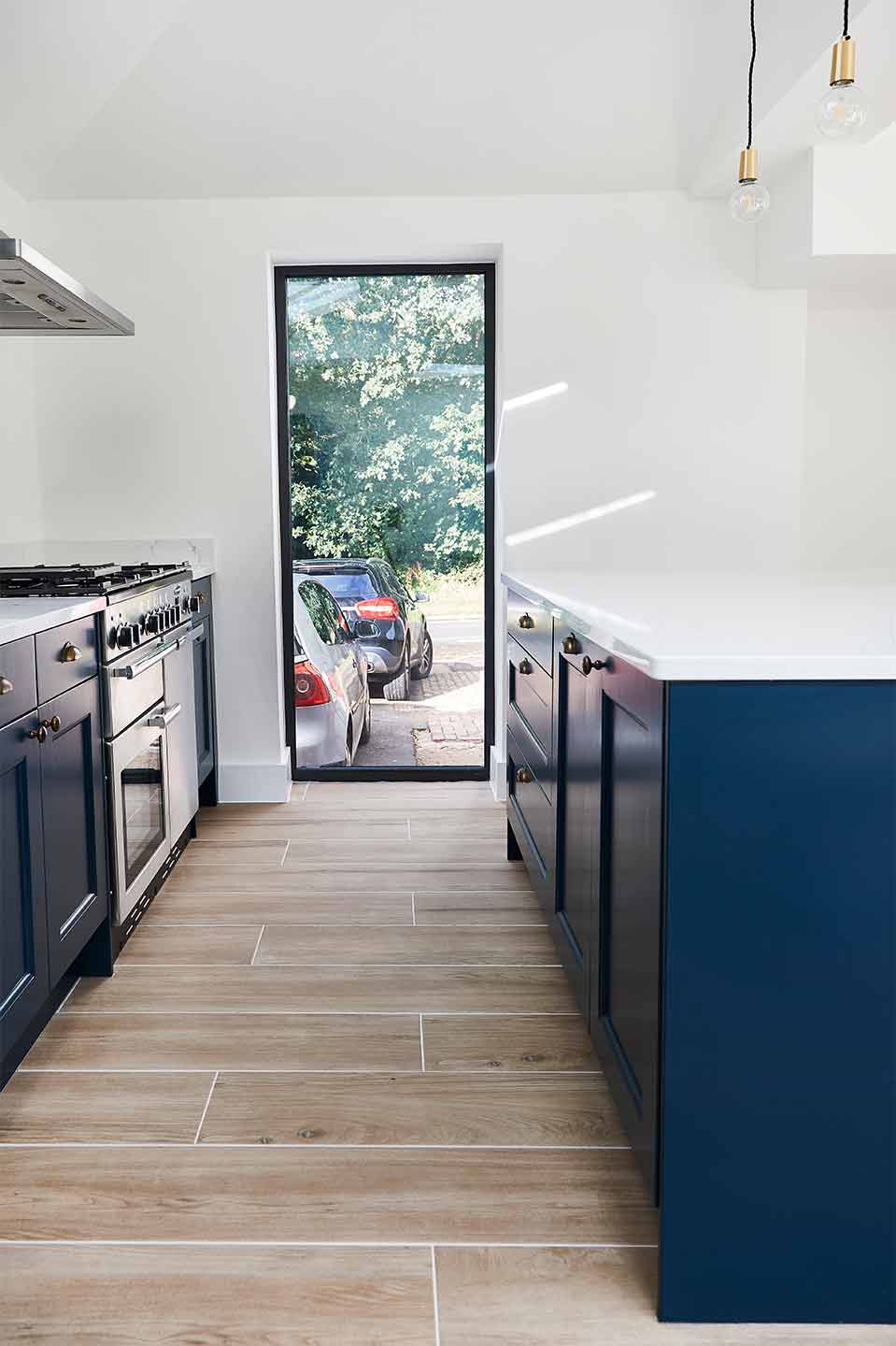 Industrial modern navy kitchen with brass accents