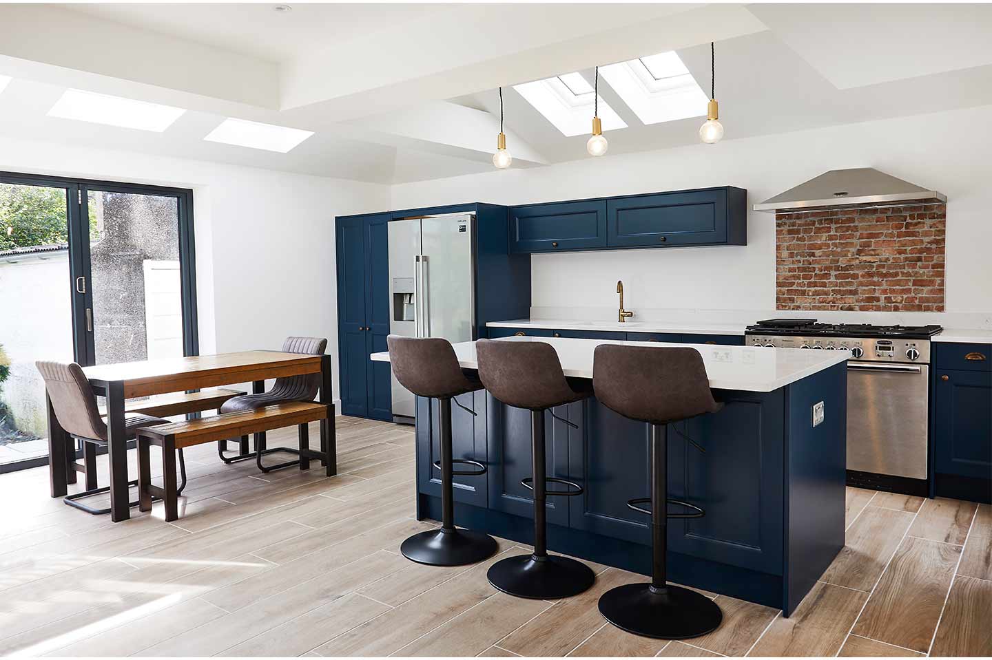 Industrial modern navy kitchen with brass accents