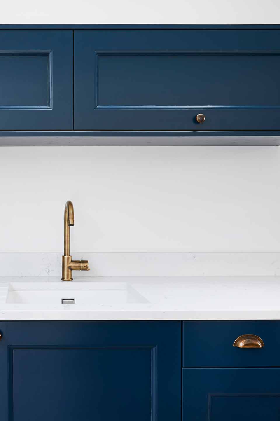 Industrial modern navy kitchen with brass accents